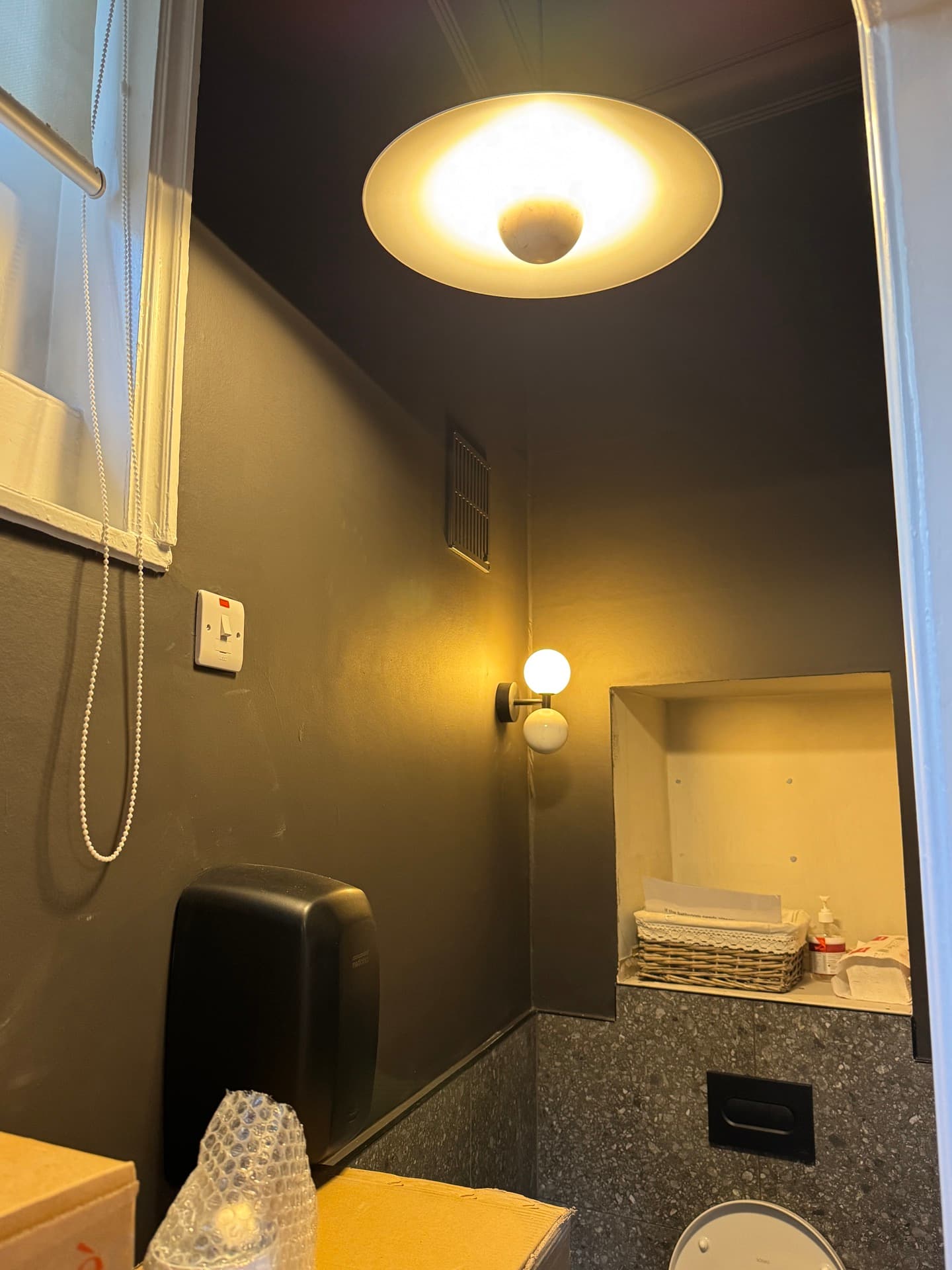 Treatment room with circular designer wall sconce, globe table lamp, and new power outlets at Harcourt Dental Clinic