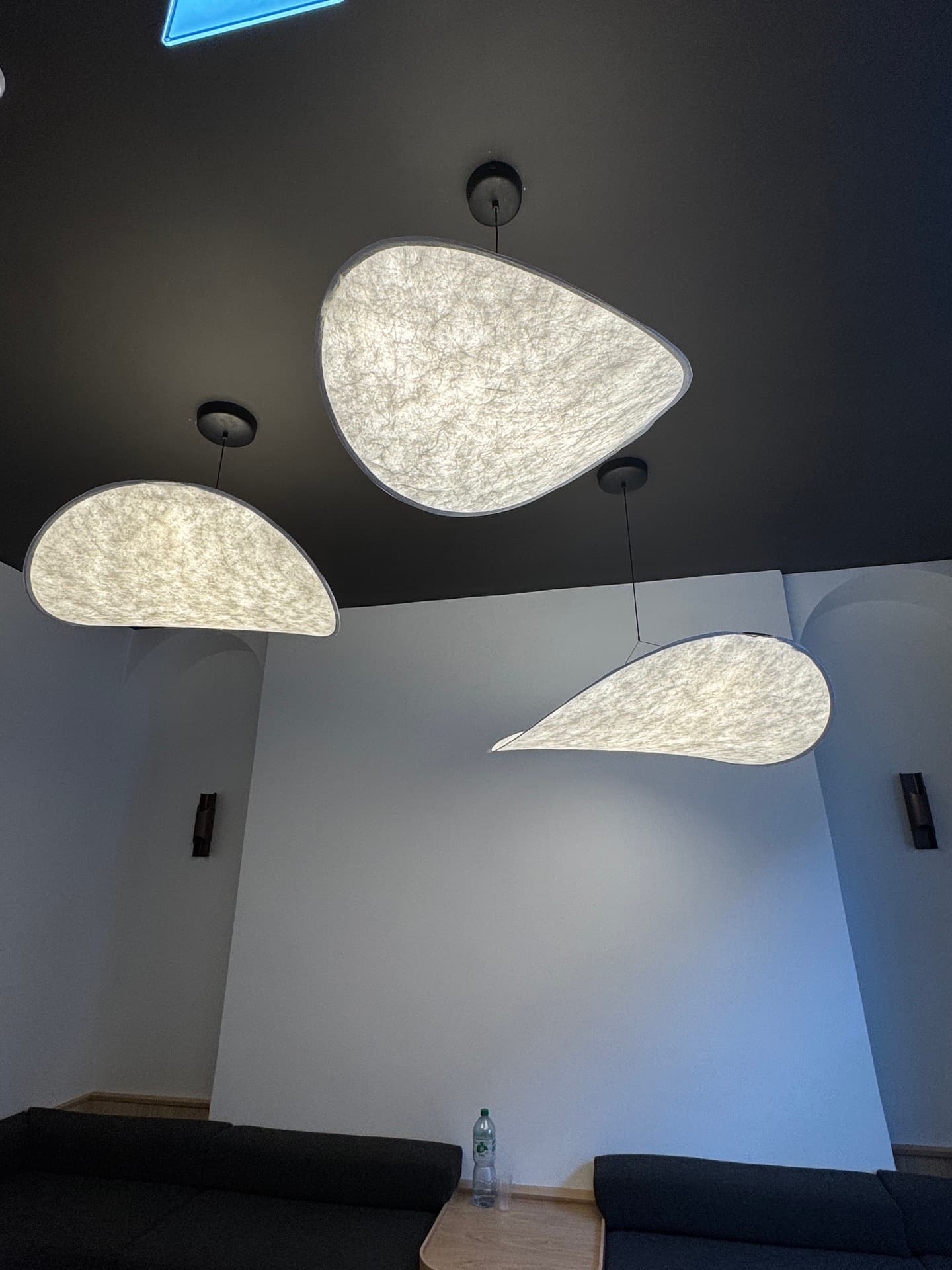 Designer teardrop wall sconces installed along a dark feature wall in Harcourt Dental Clinic corridor, Dublin 2