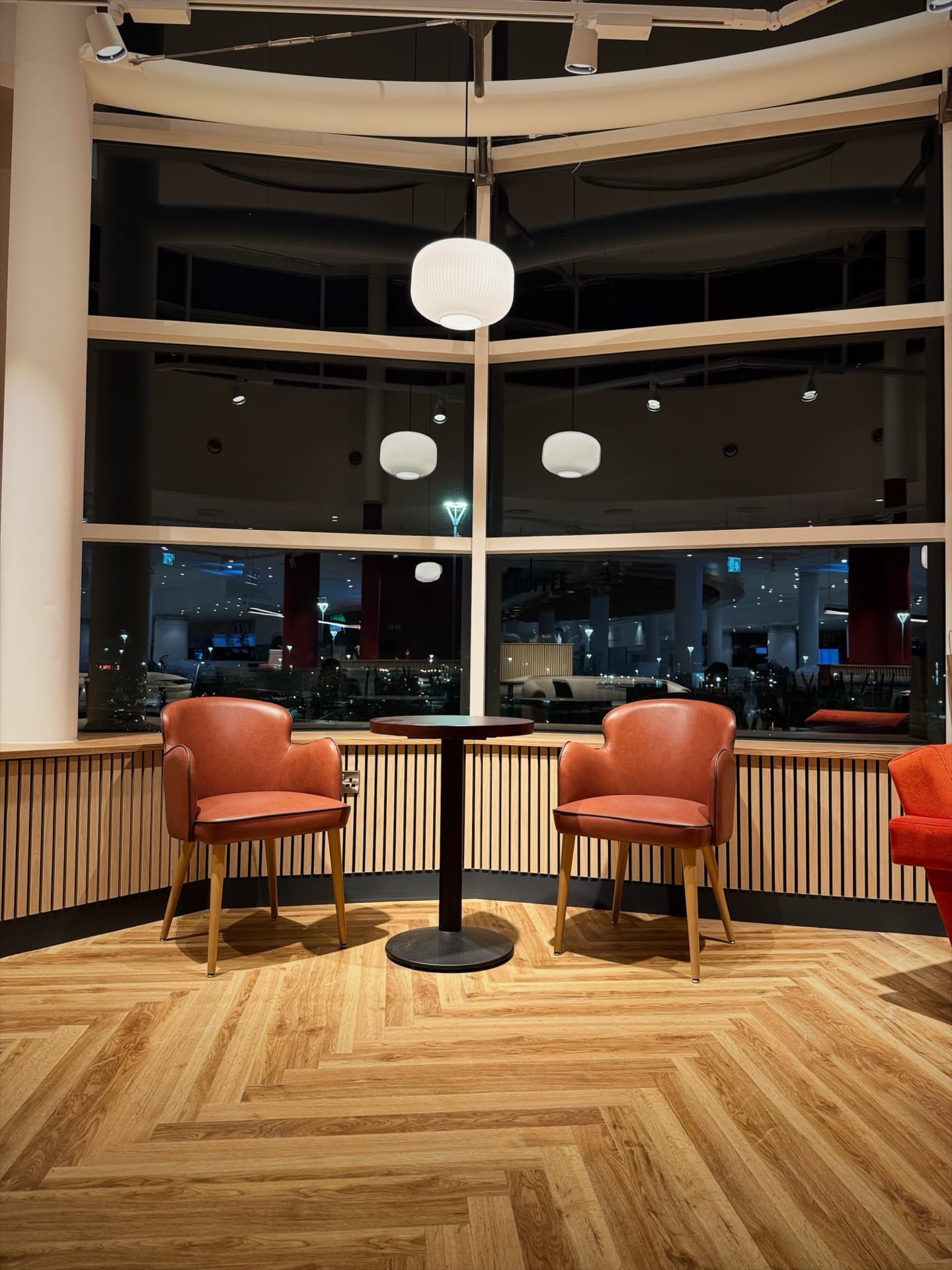 Window lounge seating with overhead globe pendant light at Insomnia Coffee Liffey Valley