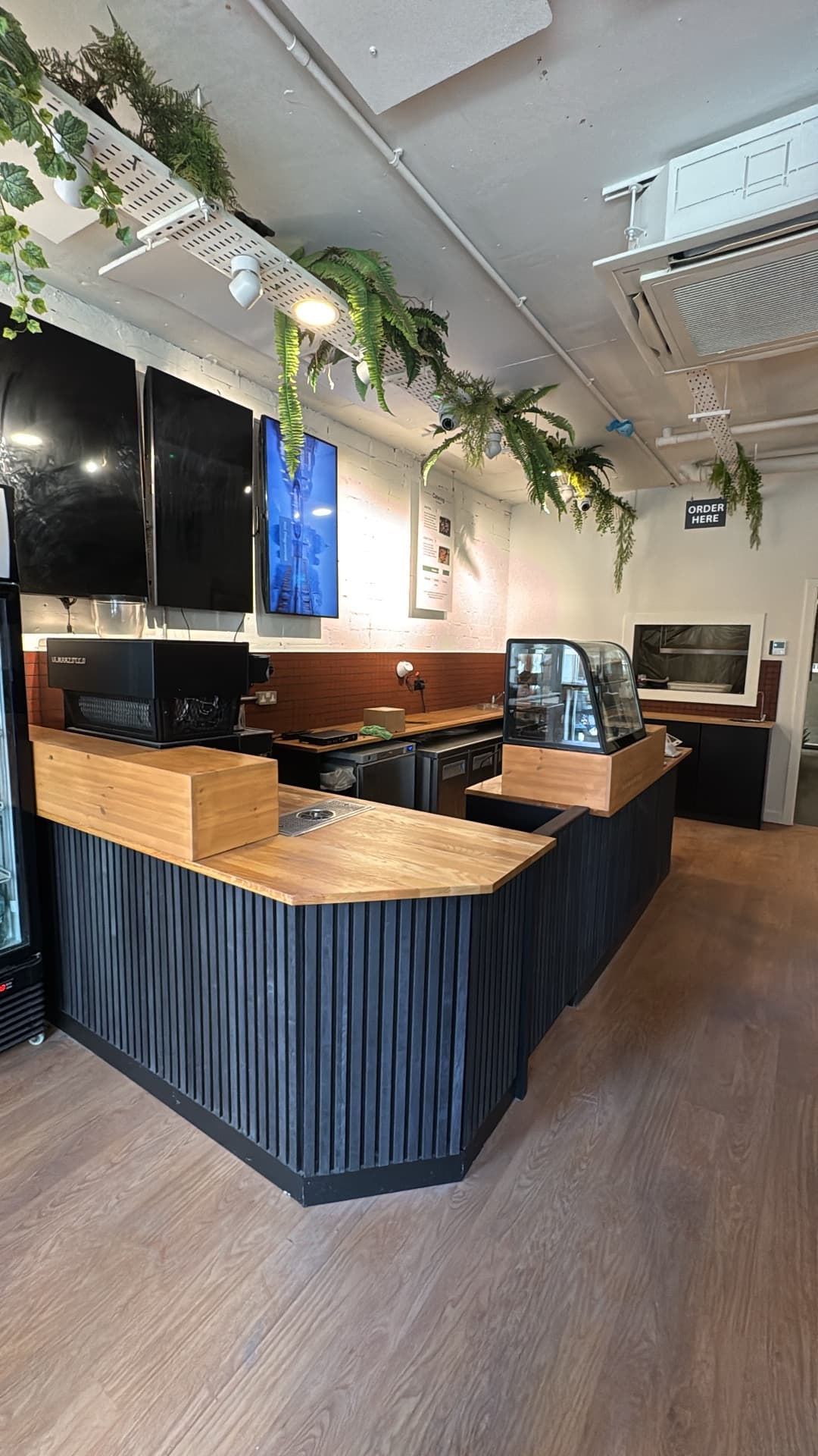 Lean Bean Coffee counter area with powered POS system, display fridge power supply, and overhead spot lighting