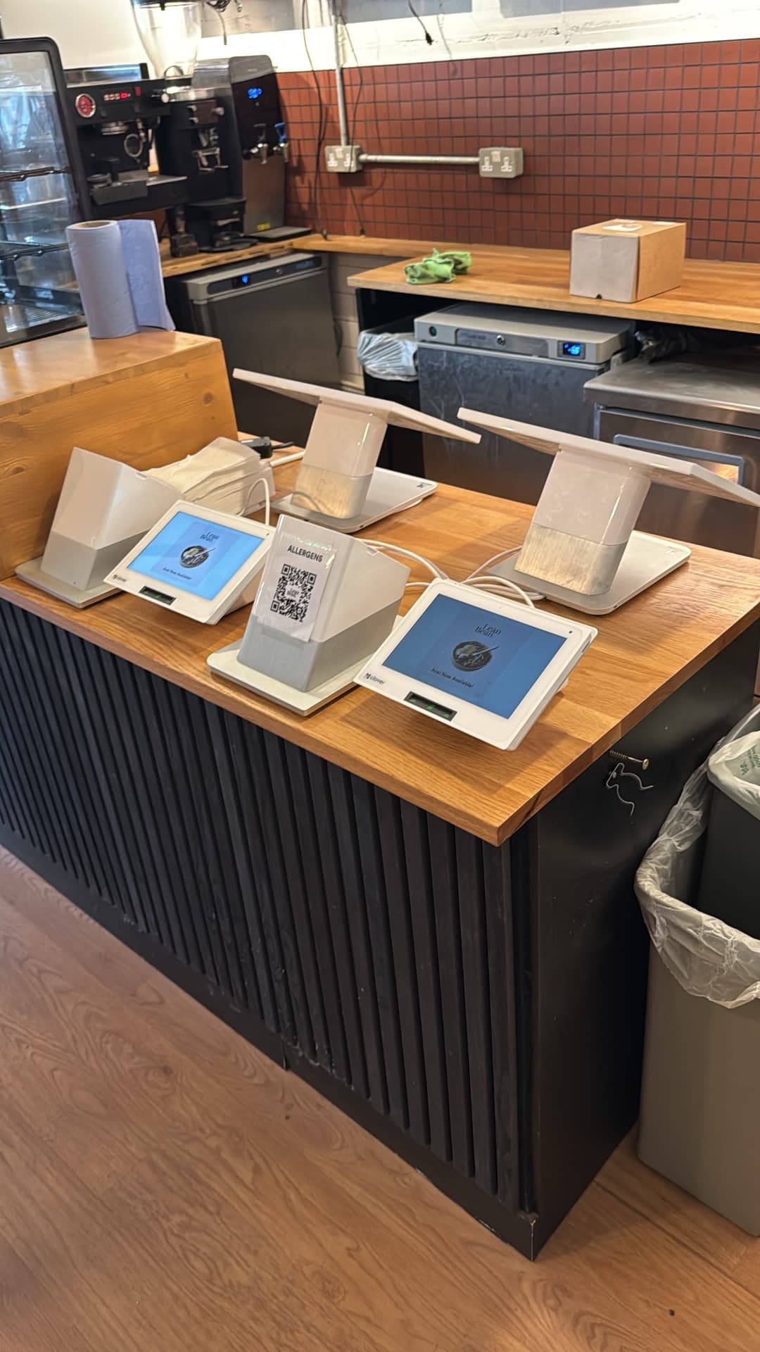 Lean Bean Coffee counter close-up showing POS tablet power supply and customer-facing charging points