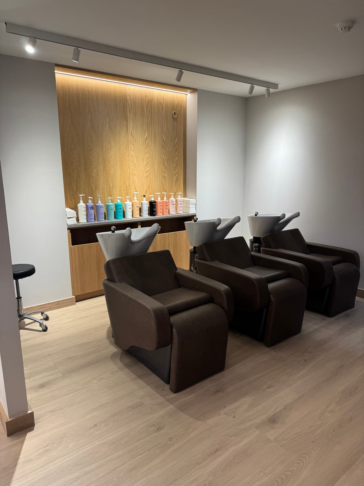 Zebra Hair Dressers wash basin area with under-shelf LED strip lighting and hair colour product display