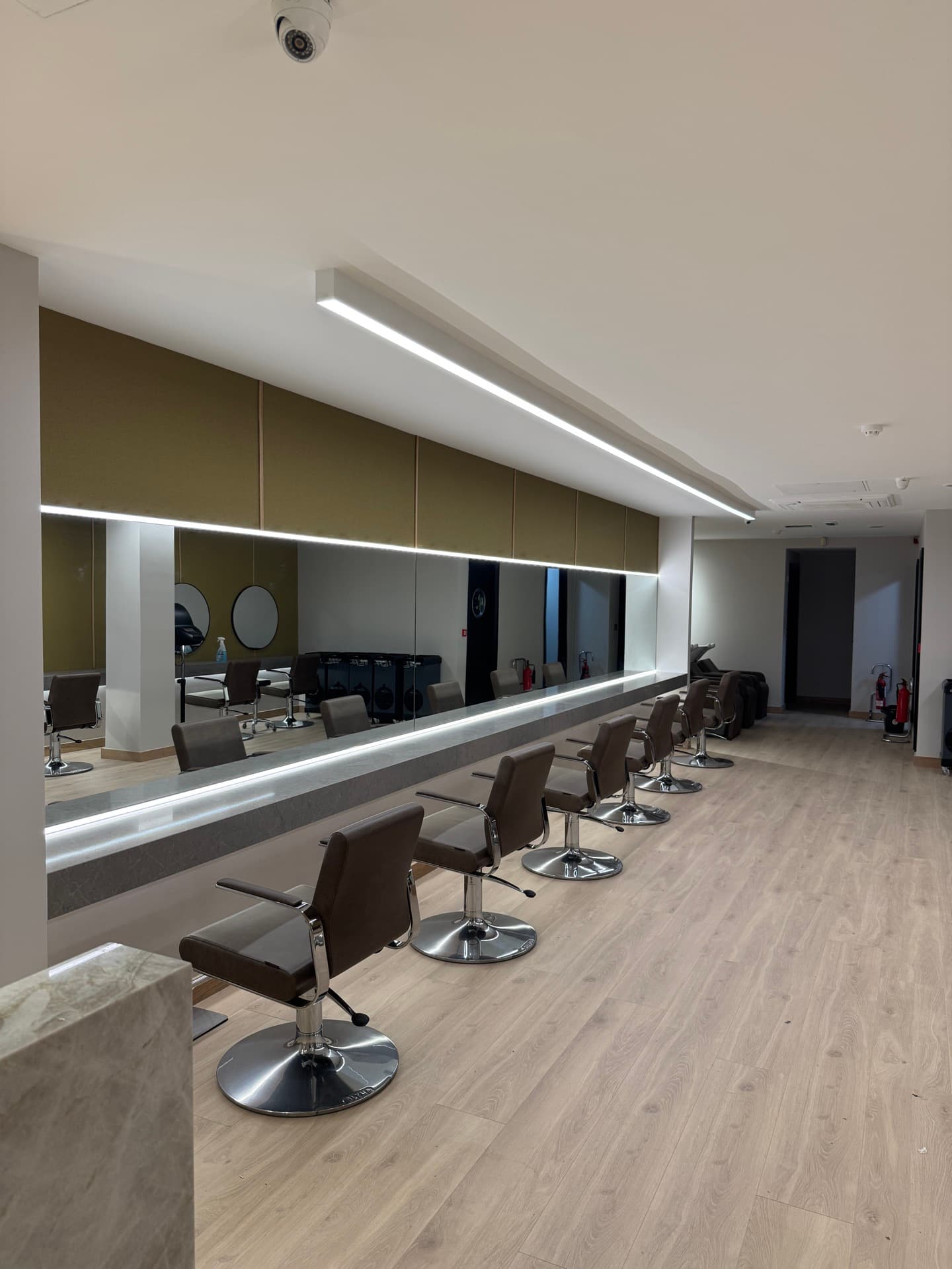 Zebra Hair Dressers salon interior showing smart LED strip lighting behind mirrors at each styling station